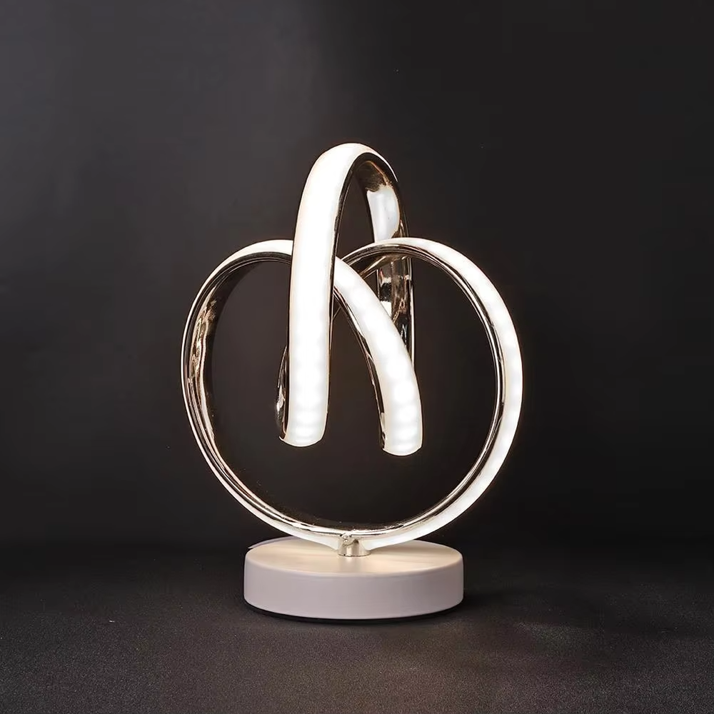 This light luxury art table lamp features a "8"/infinity symbol shape made of gold metal, with embedded LED light strips and a white marble base, serving both lighting and decorative purposes, ideal for living room side tables, bedroom bedside tables, light luxury homestays and other spaces.