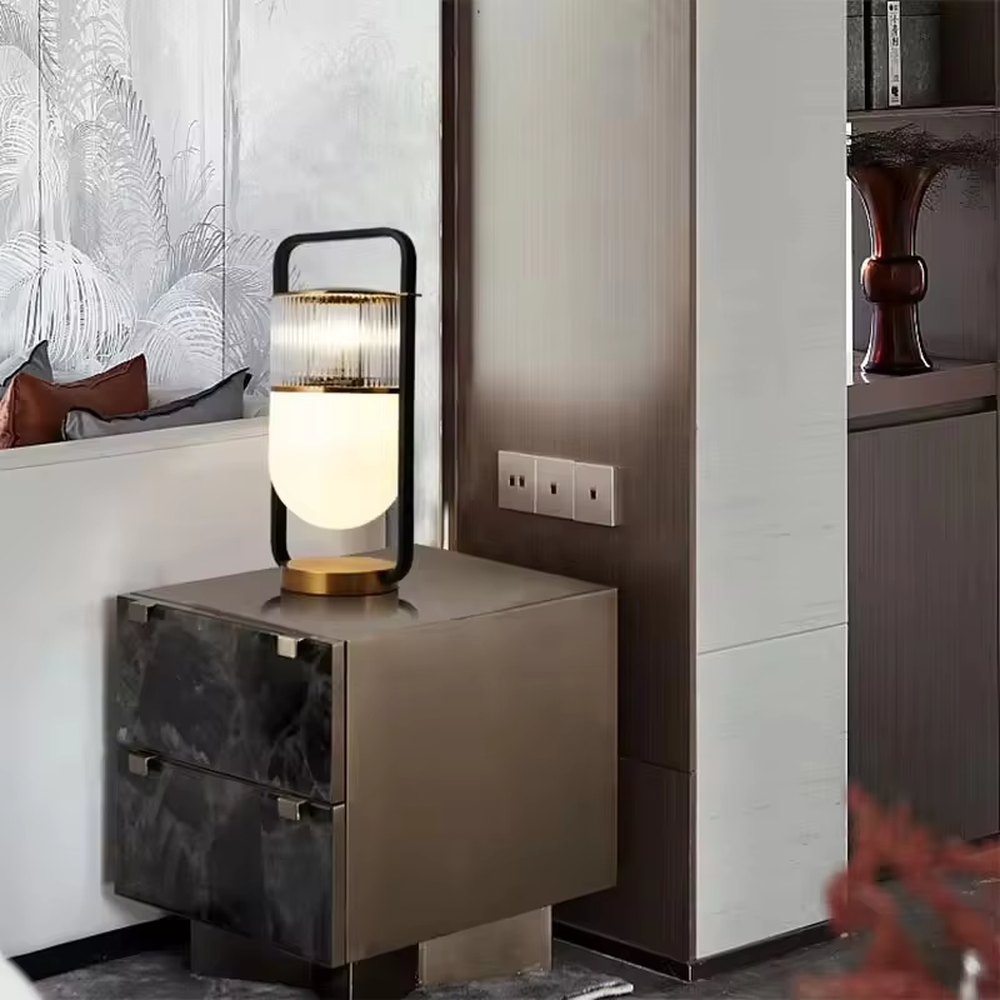 This modern light luxury lantern-shaped table lamp features a black-gold metal frame (with a handle design), paired with a double-layer lampshade of vertical-grain transparent glass and milk-white frosted glass, with an exquisite gold base. It serves both lighting and decorative purposes, ideal for light luxury spaces such as bedroom bedside tables, living room side tables, and hotel guest rooms.