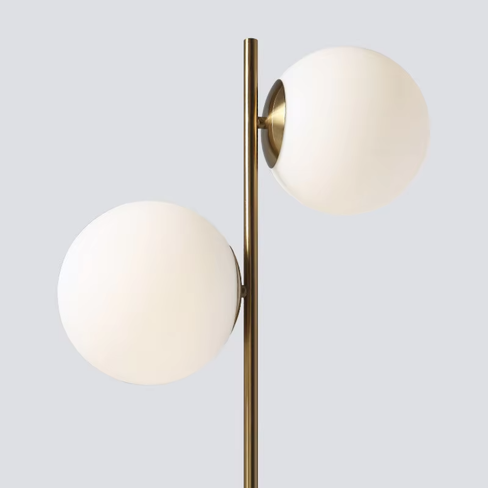 This modern light luxury double-ball table lamp features a gold metal stand, paired with milky white glass ball lampshades and a white marble base, with a simple and elegant staggered double-ball layout, serving both lighting and decorative purposes, ideal for living room side tables, bedroom bedside tables, light luxury homestays and other spaces.