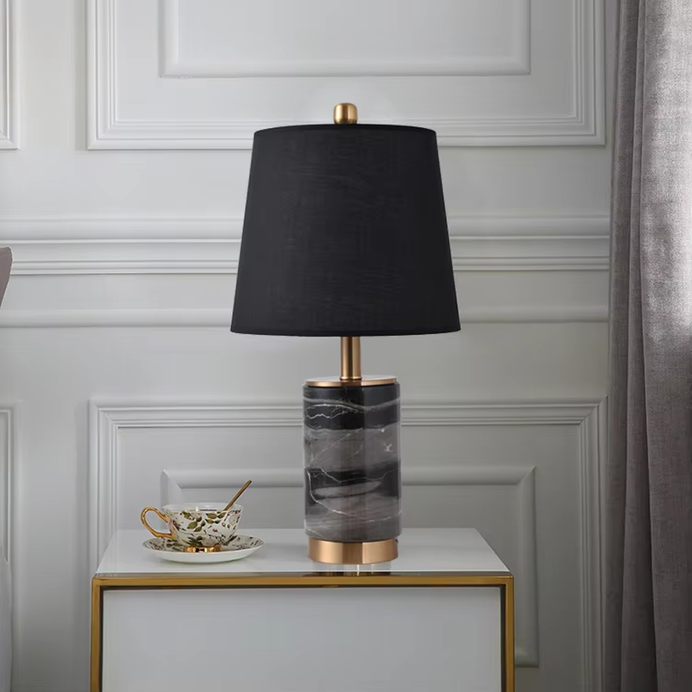 Light luxury white marble cylindrical table lamp, white marble base + golden metal decorations + beige fabric lampshade, soft warm light, creating an elegant light luxury home atmosphere.