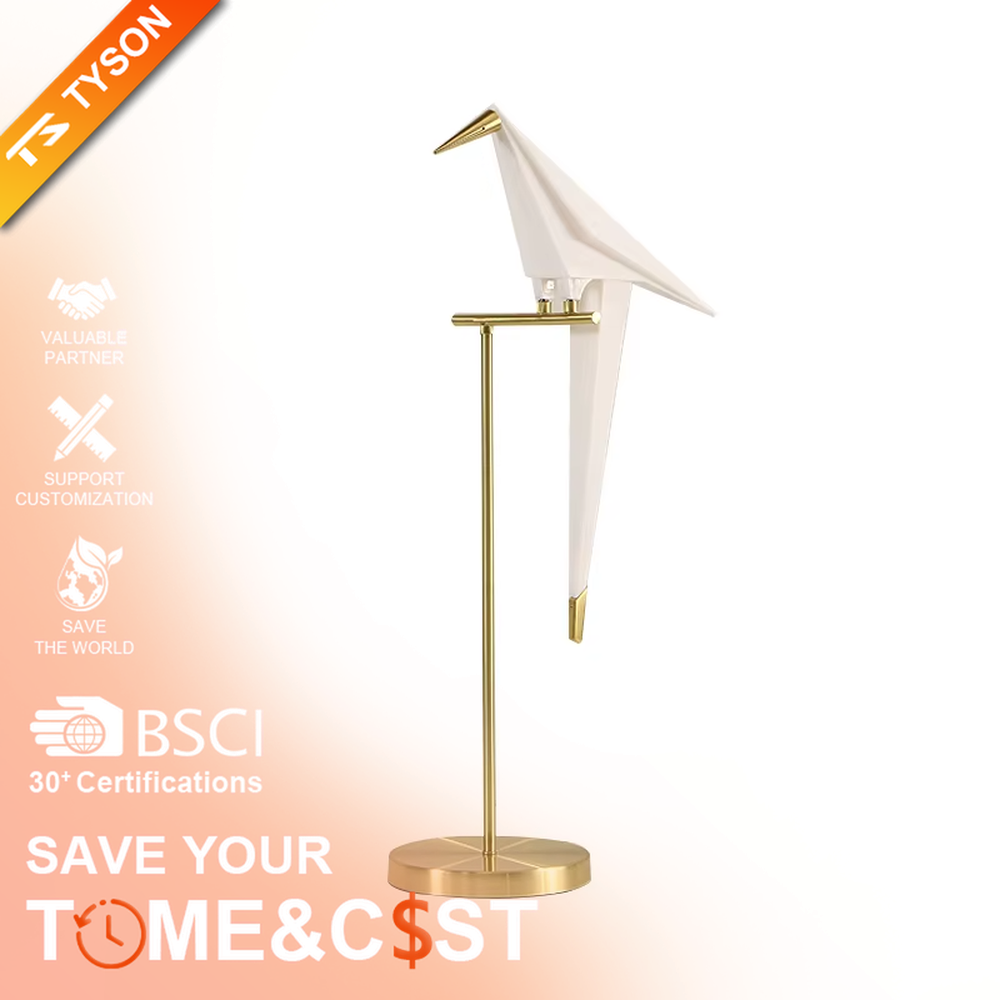 This is a modern light luxury origami crane-shaped table lamp, featuring a gold metal stand paired with a translucent paper art lamp body. The lamp body is as dynamic and soft as an origami crane, serving both lighting and artistic decoration purposes, suitable for bedroom nightstands, light luxury living room side tables, hotel guest rooms, showrooms and other scenarios.