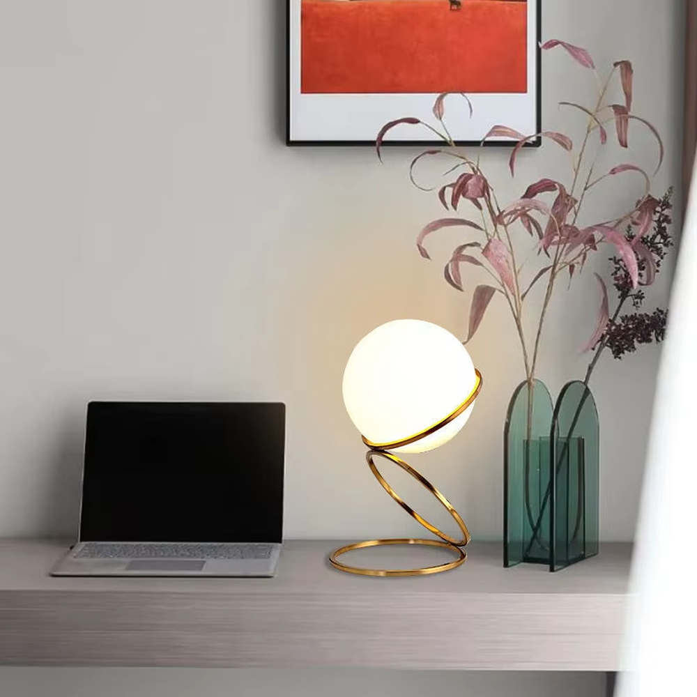 Modern planet orbit-shaped table lamp (white ball + gold ring stand), warm light effect, creating a sci-fi artistic minimalist space atmosphere.