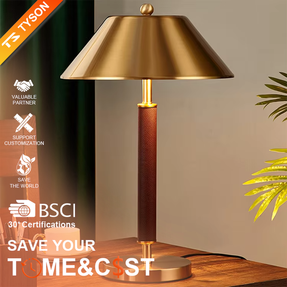 Light luxury gold-brown leather table lamp (gold metal lampshade + dark brown leather lamp post + metal base), warm light effect, creating a retro and high-end office and home atmosphere.
