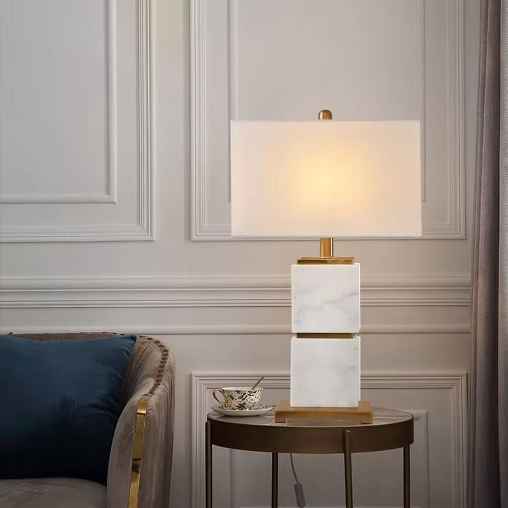 Light luxury stacked marble table lamp, natural marble base with gold metal connections, rectangular fabric lampshade for soft and eye-protective lighting, designed to enhance space texture, suitable for bedroom nightstands, living room side tables, hotel guest rooms, etc.