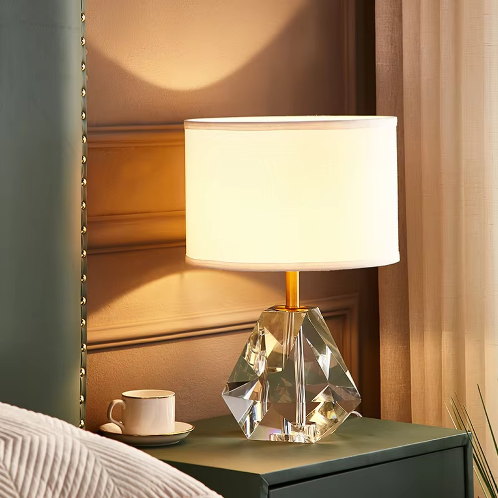 Light luxury multi-faceted cut crystal base table lamp (white shade + gold trim), warm light effect, creating a brilliant and exquisite space atmosphere.