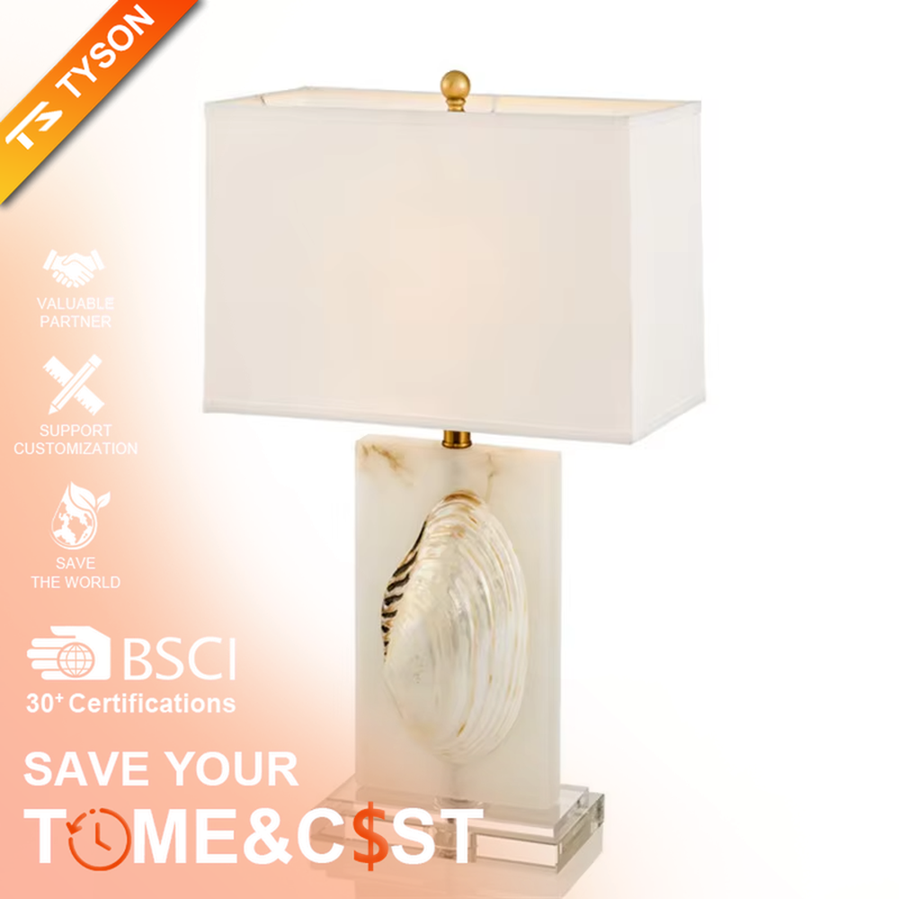 This light luxury modern table lamp features a light-colored stone base with shell relief, paired with gold metal connectors and an off-white fabric rectangular lampshade. It serves both lighting and decorative purposes, ideal for light luxury spaces such as bedroom bedside tables, living room side tables, and hotel guest rooms.