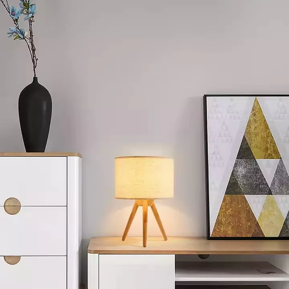 Wooden-style triangular stand table lamp (wooden tripod + linen lampshade), warm light effect, creating a natural and healing home atmosphere.