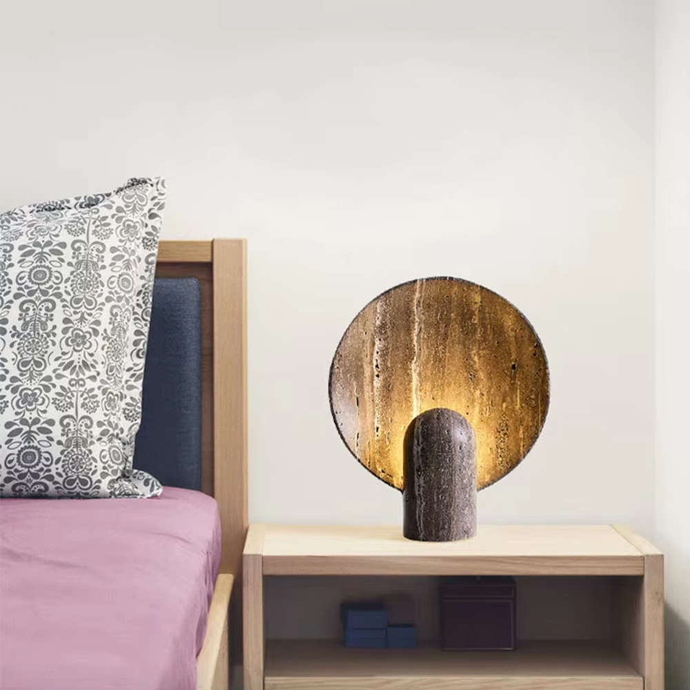 Industrial retro stone-texture base + circular metal texture lampshade table lamp, warm light effect, creating a rustic artistic atmosphere.