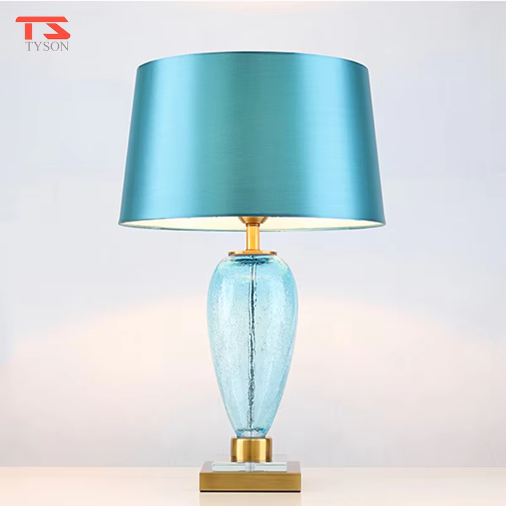 Light luxury lake blue glass bottle-shaped table lamp (satin fabric shade + gold trim), warm light effect, creating a fresh and elegant space atmosphere.