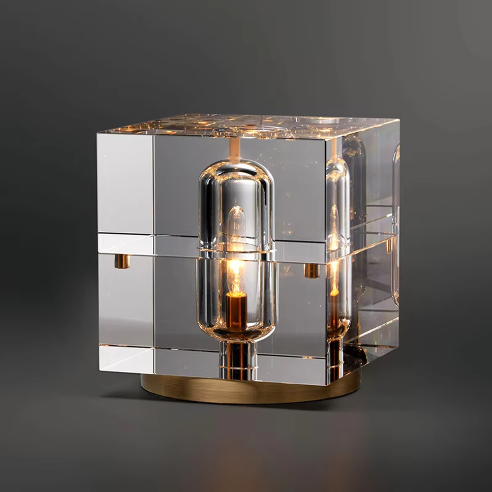 Modern light luxury transparent square column crystal shade gold base Edison bulb table lamp, warm light effect, creating a retro luxurious atmosphere.