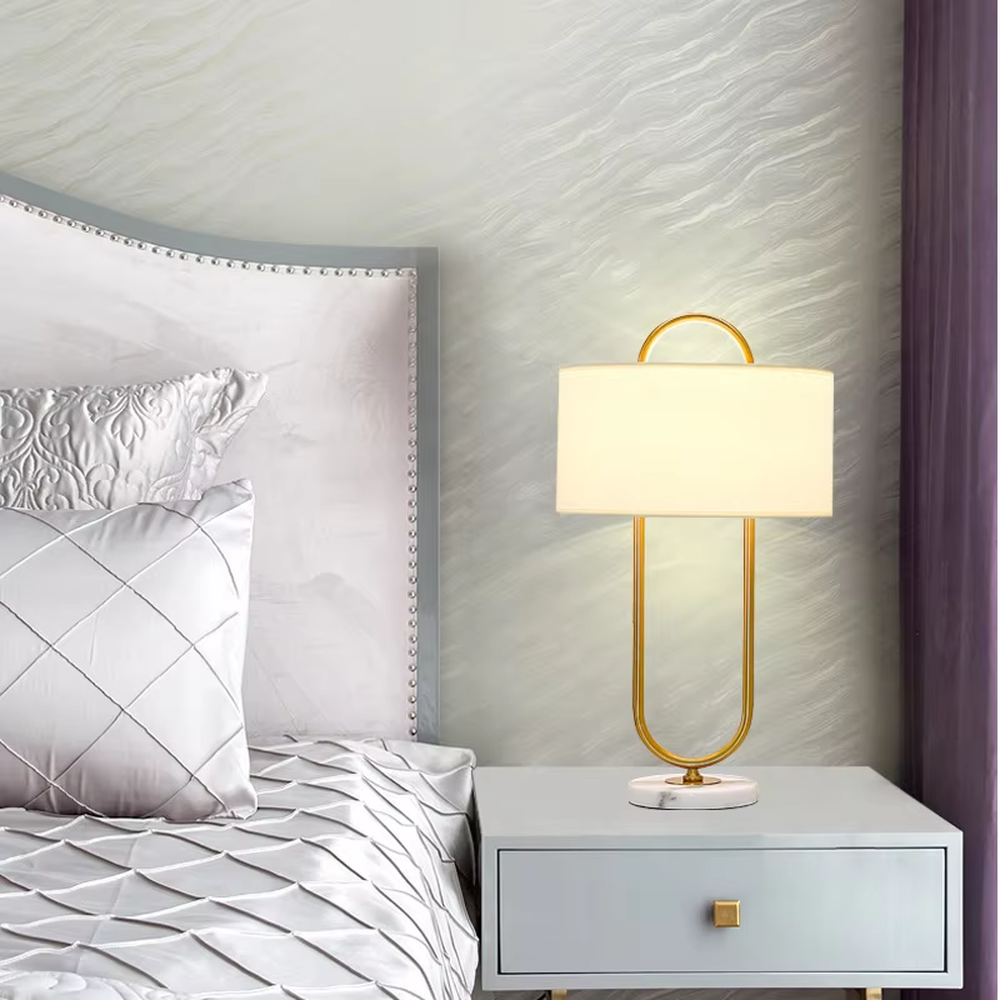 Light luxury U-shaped gold frame table lamp (gold U-shaped stand + fabric shade + marble base), warm light effect, creating an elegant and high-end home atmosphere.