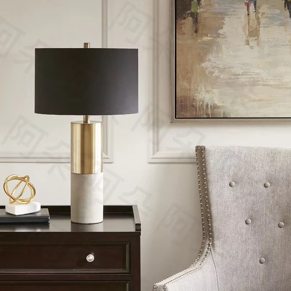 This light luxury table lamp features a black marble (with white veins) base, paired with a gold metal cylindrical lamp body and an off-white fabric cylindrical lampshade, with a gold spherical decoration on top. It serves both lighting and decorative purposes, ideal for light luxury spaces such as bedroom bedside tables, living room side tables, and hotel guest rooms.