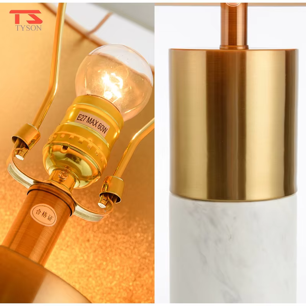 This is a light luxury marble-metal splicing table lamp, with a white fabric lampshade paired with a base made of gold metal and gray marble, accented with an orange decorative ball on top, featuring both decorative and lighting functions, ideal for high-end indoor scenarios such as bedroom nightstands and living room side tables.