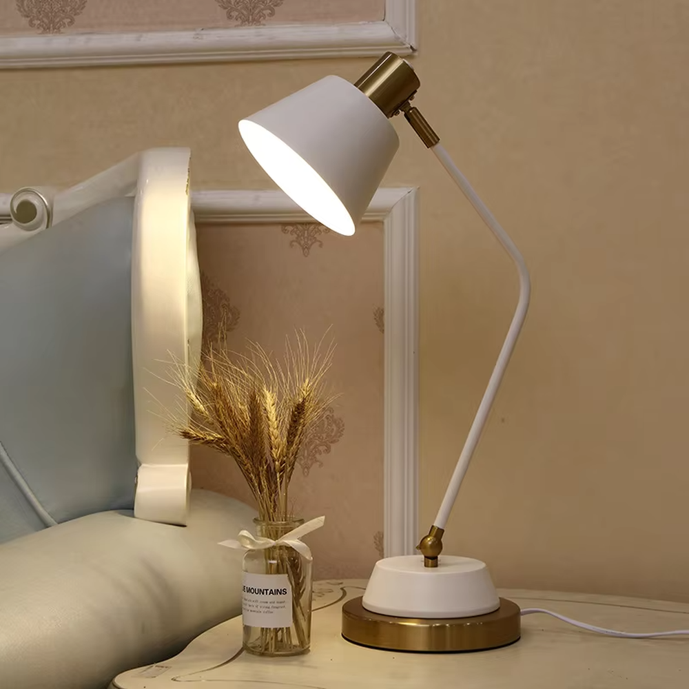 This modern minimalist table lamp features a white-gold color scheme, with a bendable metal arm and a conical lampshade, and a base with gold decoration. It serves both lighting and decorative purposes, ideal for bedroom bedside tables, study desks, light luxury homestays and other scenarios.