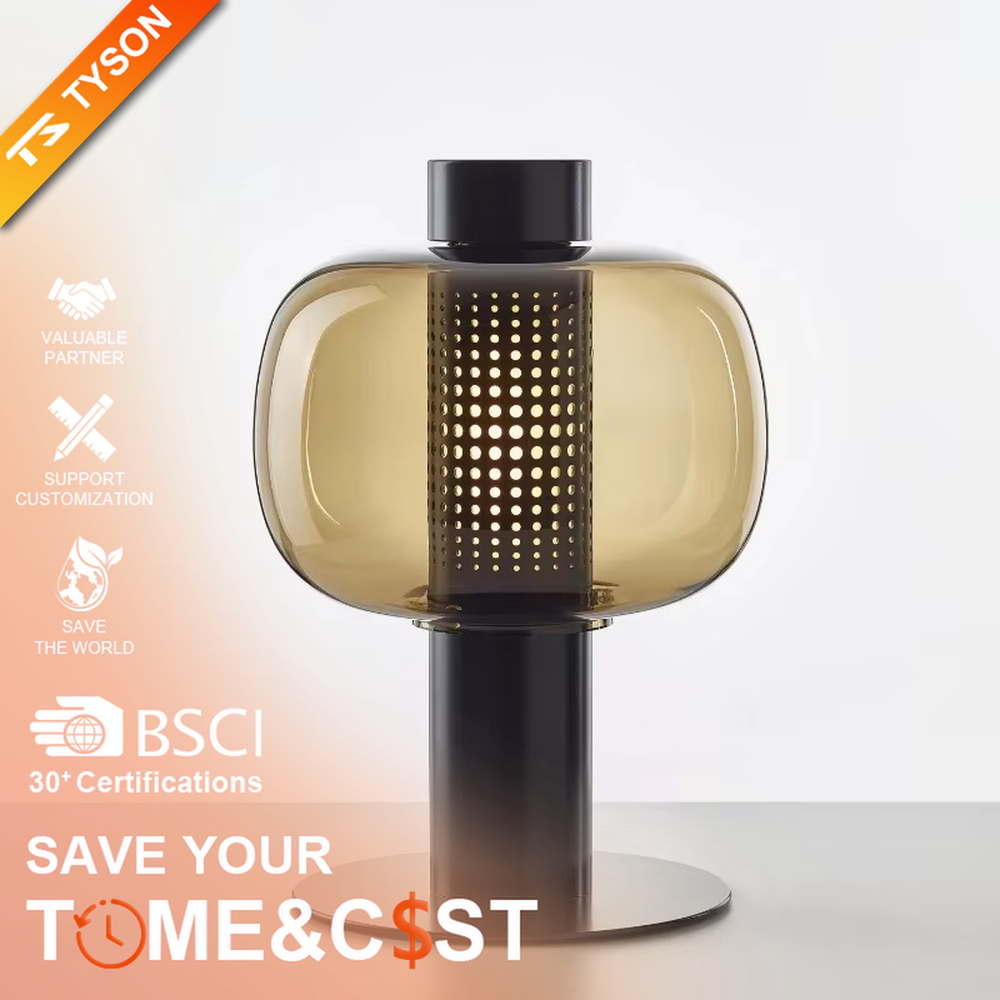 This modern minimalist table lamp features a copper-colored metal frame, paired with an oval smoked glass lampshade and a perforated metal lamp core. Its shape combines roundness with industrial details, and light passes through the perforations and glass to create soft, dappled light and shadow. It serves both lighting and decorative purposes, ideal for bedroom bedside tables, living room side tables, hotel guest rooms, and modern office spaces.