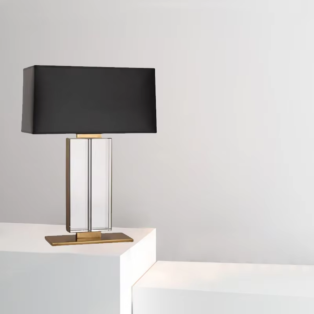 This is a modern light luxury crystal column table lamp, with a black rectangular fabric lampshade paired with a transparent cut crystal column base, accented with gold metal details, featuring both decorative and lighting functions, ideal for high-end indoor scenarios such as living room side tables and bedroom nightstands.