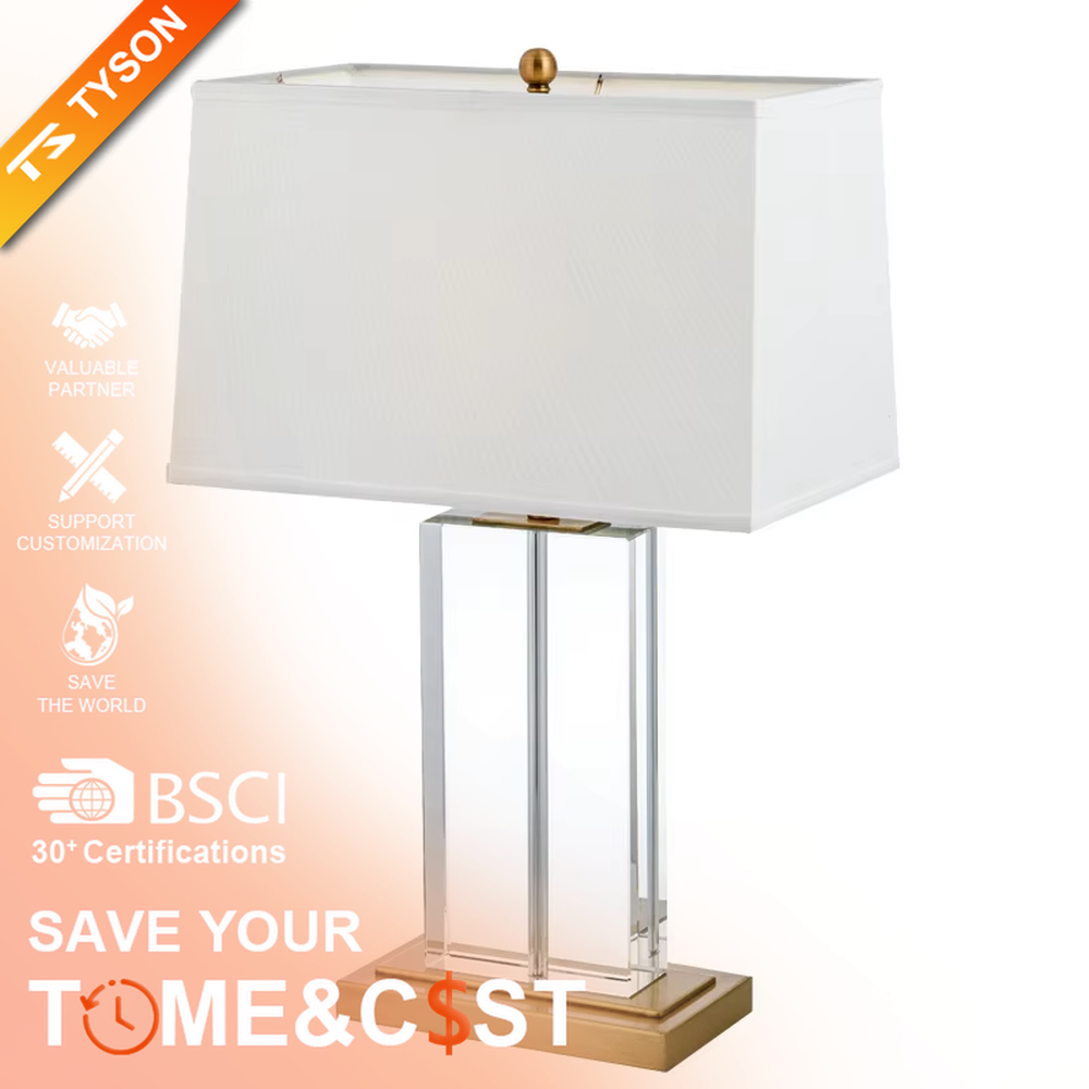This modern light luxury table lamp features an off-white fabric lampshade (trimmed with a thin gold edge), paired with a transparent crystal square column lamp pole and a gold metal base. The overall style is simple and elegant, with soft eye-protective light, serving both lighting and decorative purposes, suitable for modern light luxury style spaces such as bedrooms, living rooms, and hotel guest rooms.