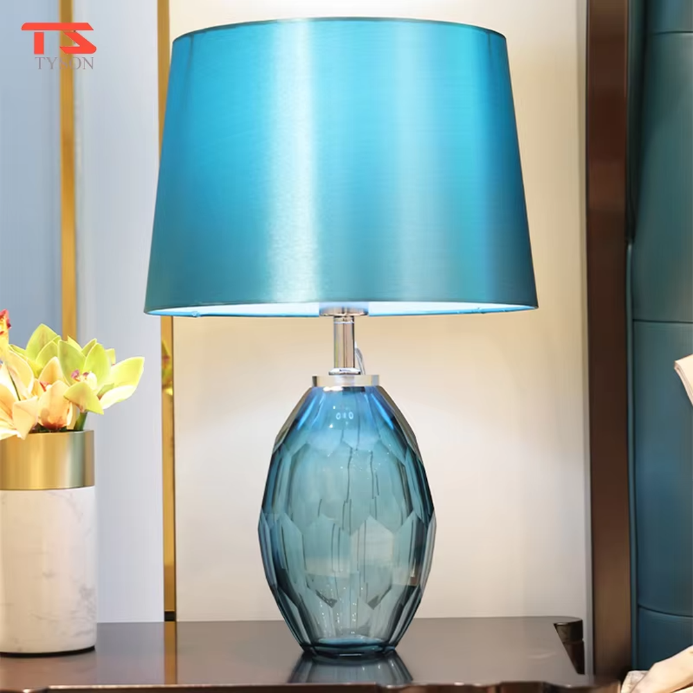 This light luxury modern table lamp features a blue-gray cut-textured glass lamp body, paired with a sky-blue fabric conical lampshade, with exquisite metal connectors. It serves both lighting and decorative purposes, ideal for light luxury spaces such as bedroom bedside tables, living room side tables, and hotel guest rooms.