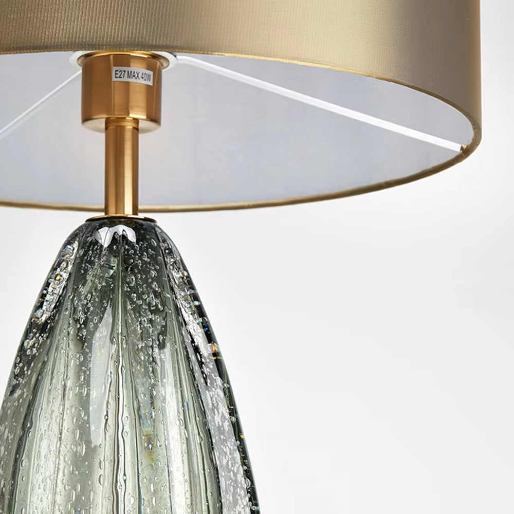 Light luxury textured glass table lamp (dark green glass + metal base), warm light effect, creating an elegant and high-end home space atmosphere.