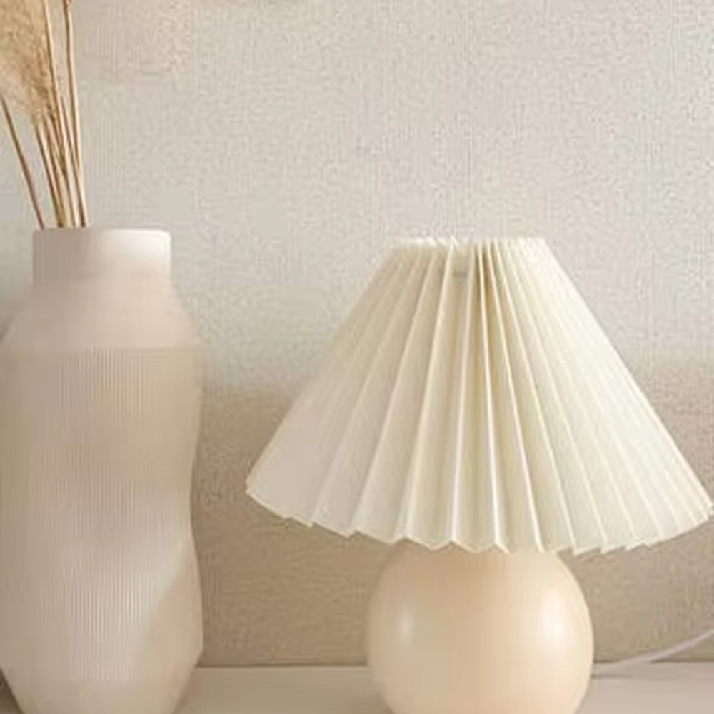 Fresh pleated umbrella shade table lamp (cream yellow glaze ball body + white pleated shade), warm light effect, creating a soft and healing home atmosphere.