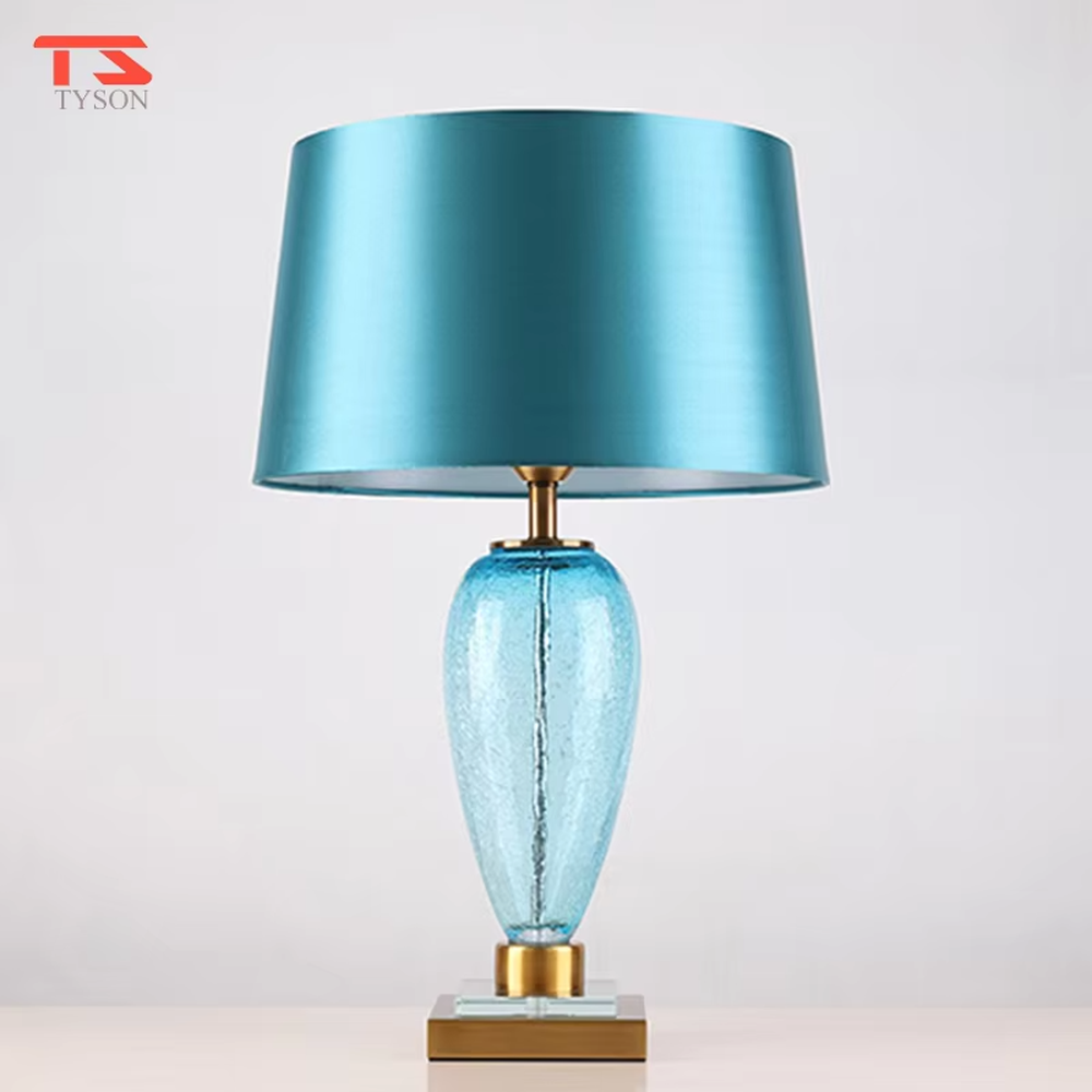 Light luxury lake blue glass bottle-shaped table lamp (satin fabric shade + gold trim), warm light effect, creating a fresh and elegant space atmosphere.