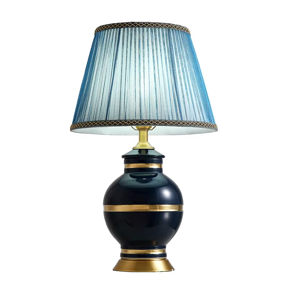 This is a light luxury European-style ceramic table lamp, with a dark blue ceramic base paired with gold metal decorations, and a light blue vertical-striped fabric lampshade edged with a gold ribbon, which has both lighting and decorative functions, suitable for bedroom nightstands, living room side tables, hotel guest rooms and other spaces.
