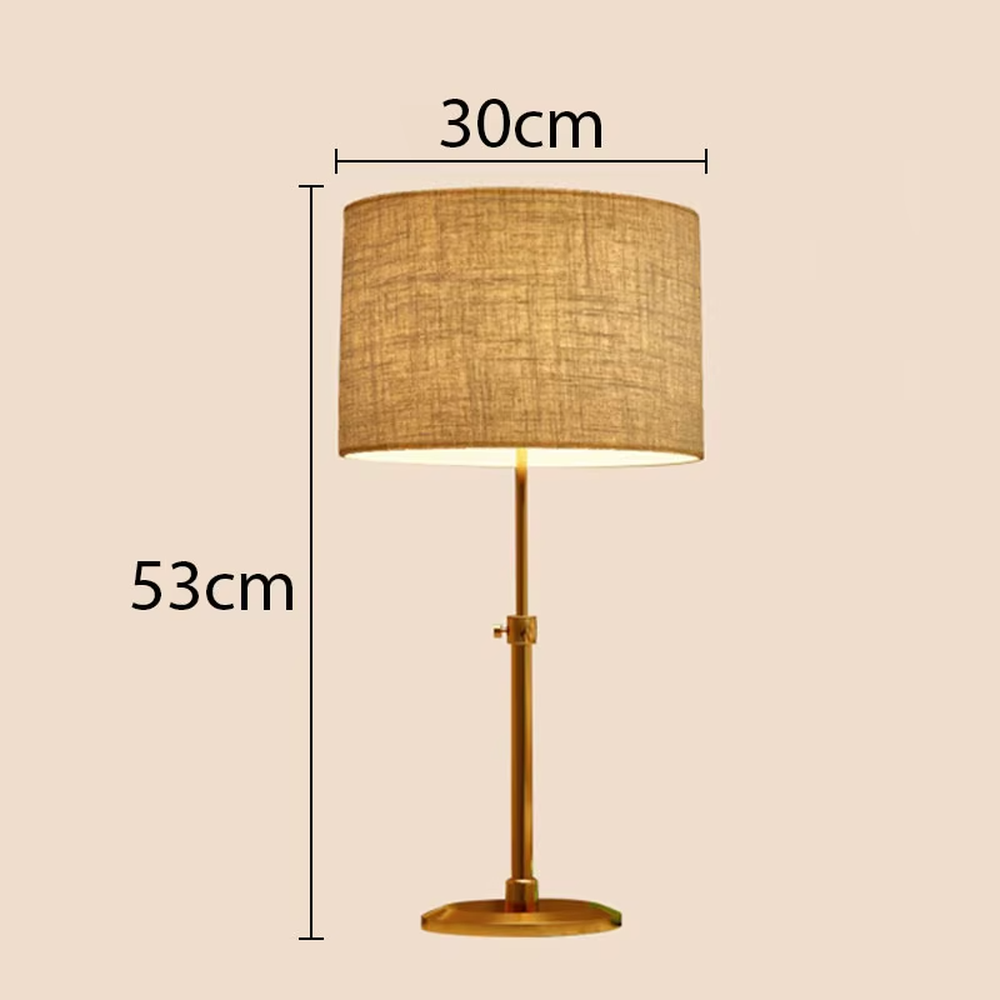 Light luxury golden hollow pattern table lamp (white fabric shade), warm light effect, creating an exquisite retro space atmosphere.