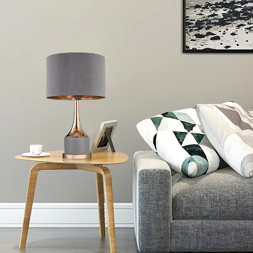 Light luxury gray-gold fabric lampshade metal base table lamp (gray fabric shade + gold pole + gray stone-pattern base), warm light effect, creating an exquisite and elegant atmosphere.