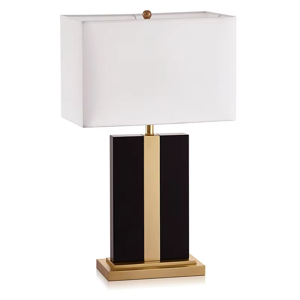 Modern light luxury marble and metal spliced table lamp, with a gray marble lamp body paired with gold metal decorative strips, a light gray fabric rectangular lampshade (with a gold ball decoration on top), emitting soft and elegant light, combining decorativeness and practicality, suitable for lighting and decoration in spaces such as bedroom nightstands, living room side tables, and hotel guest rooms.