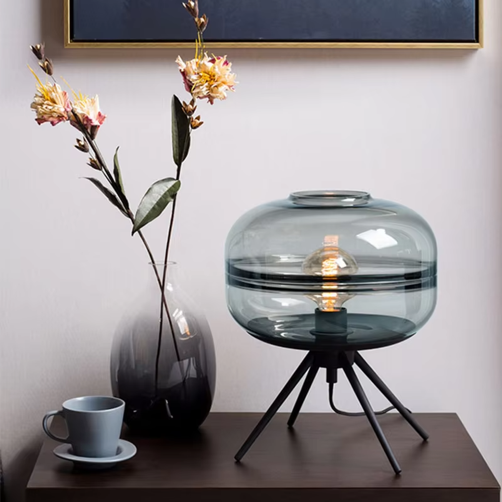 Light luxury dark green glass ball table lamp (dark green double-layer glass ball + black triangular stand), warm light effect, creating a fresh and high-end home atmosphere.