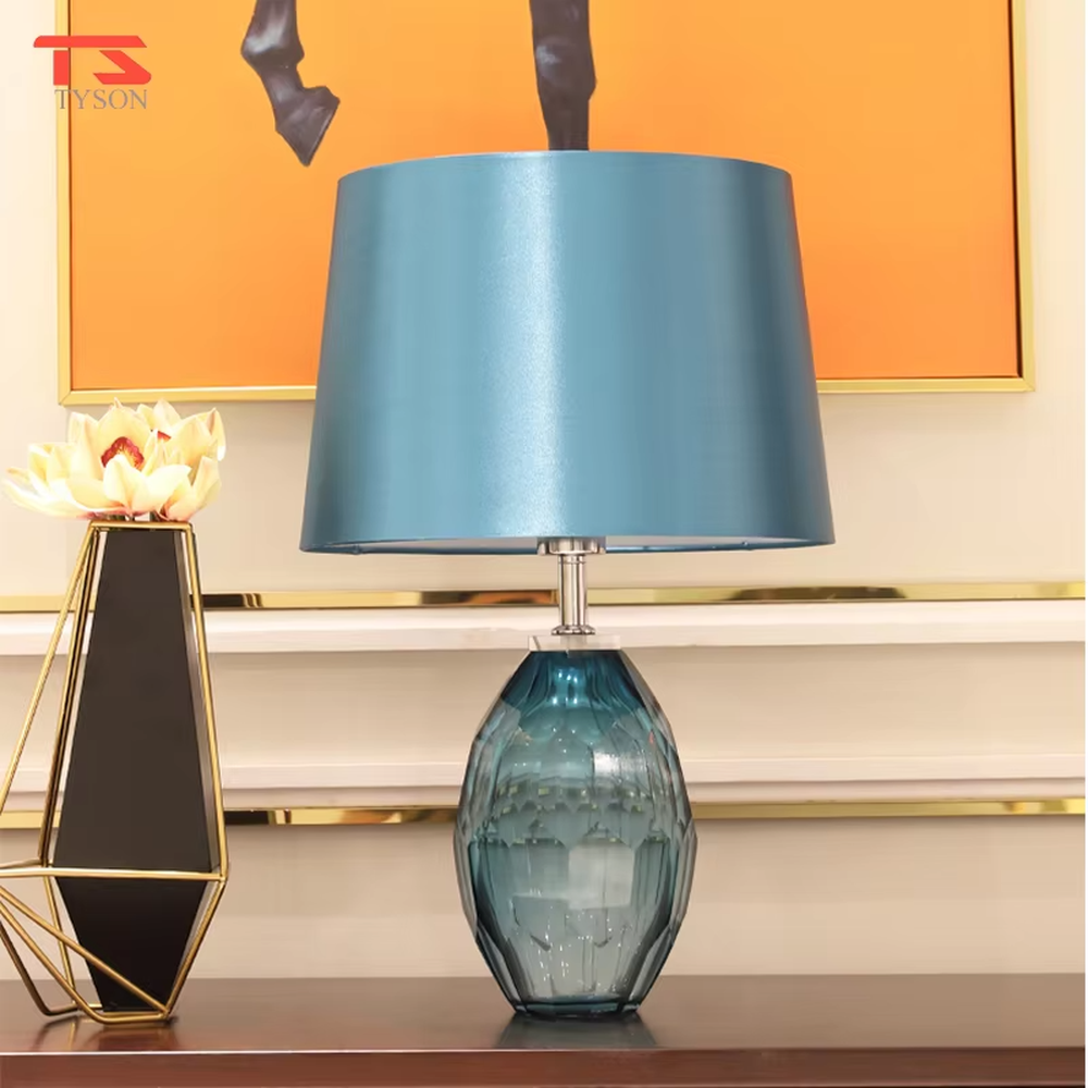 This light luxury modern table lamp features a blue-gray cut-textured glass lamp body, paired with a sky-blue fabric conical lampshade, with exquisite metal connectors. It serves both lighting and decorative purposes, ideal for light luxury spaces such as bedroom bedside tables, living room side tables, and hotel guest rooms.