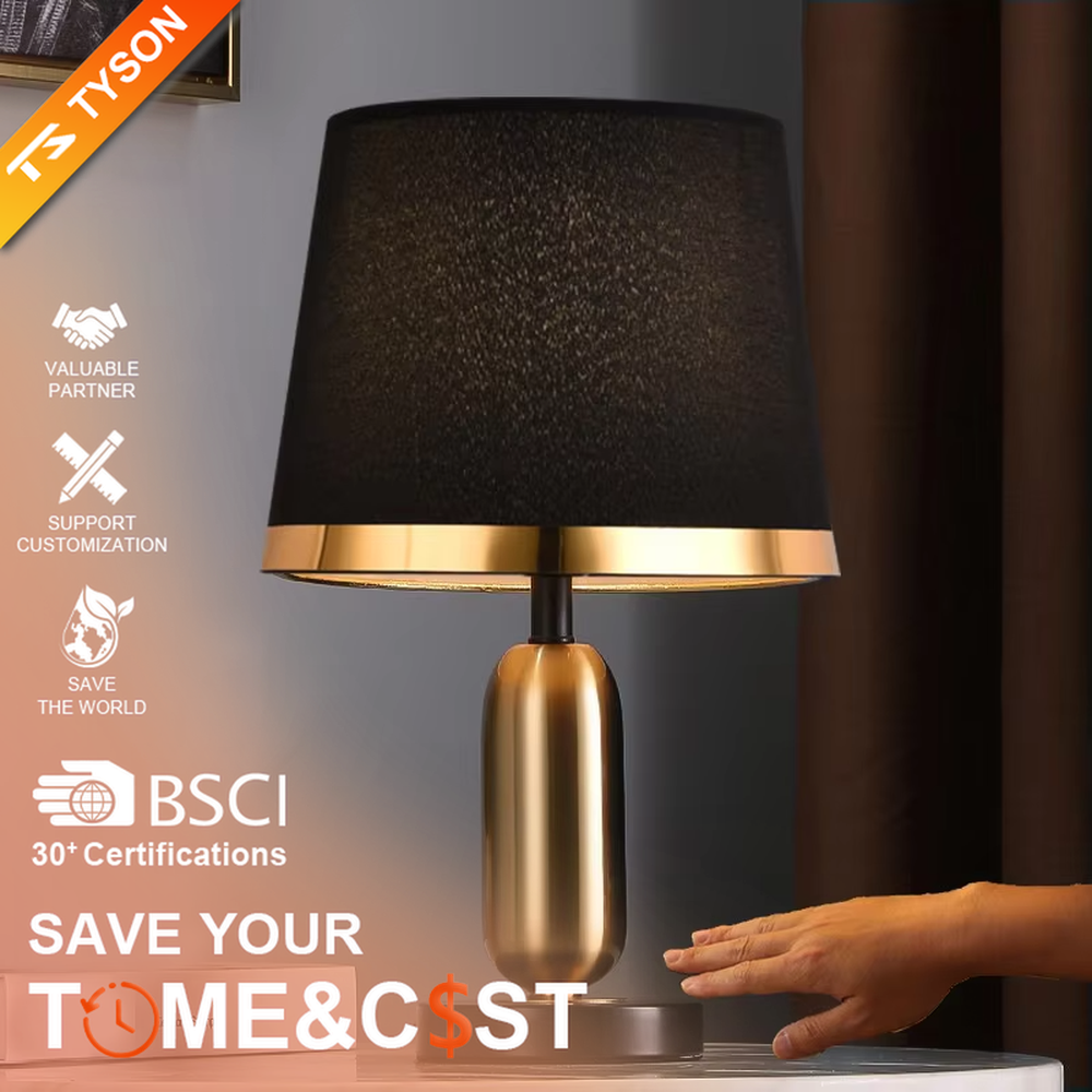 This is a light luxury minimalist style table lamp, featuring a gold metal lamp body paired with an off-white fabric lampshade. The black and gold color scheme offers a high-end texture, emitting soft and uniform light, serving both lighting and decorative purposes, suitable for bedroom nightstands, hotel guest rooms, light luxury living room side tables and other scenarios.