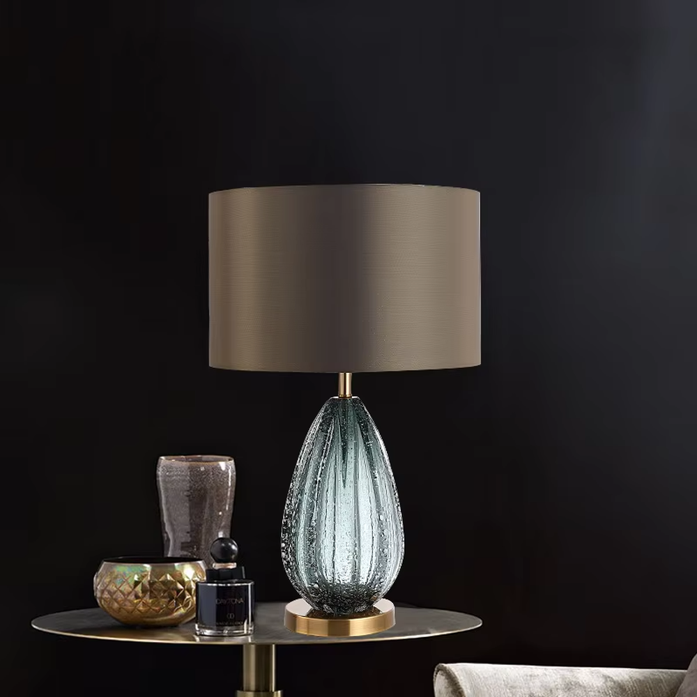 Light luxury textured glass table lamp (dark green glass + metal base), warm light effect, creating an elegant and high-end home space atmosphere.