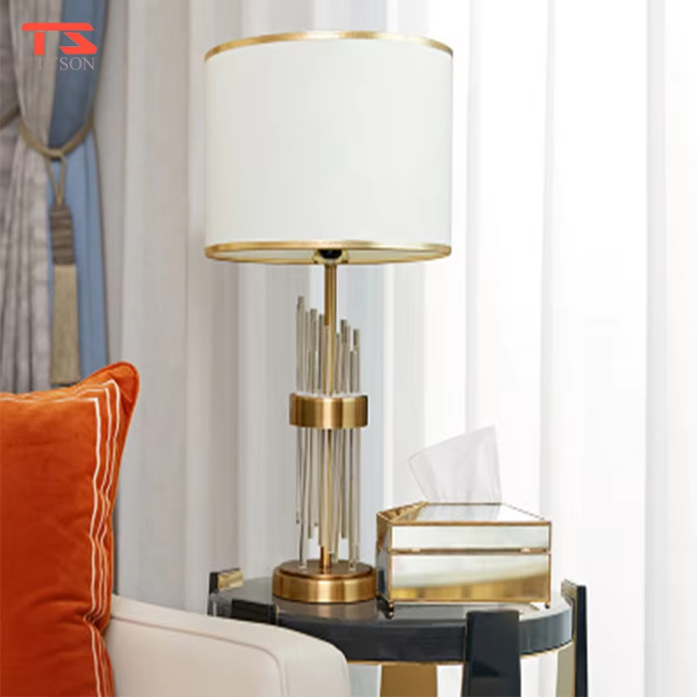 This is a light luxury crystal-metal splicing table lamp, with an off-white fabric lampshade edged with gold trim, a lamp post made of transparent crystal strips and gold metal, and a gold metal base, featuring both decorative and lighting functions, ideal for high-end indoor scenarios such as bedroom nightstands and living room side tables.
