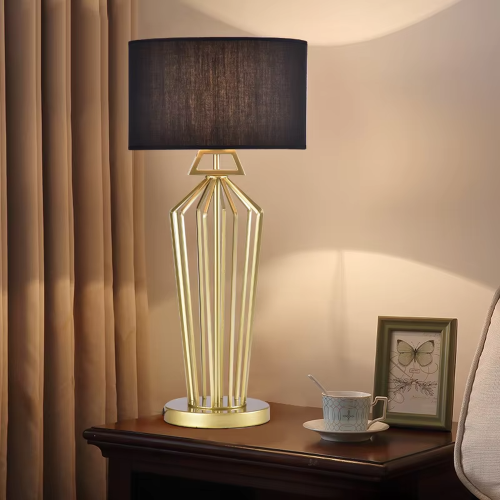 Modern Light Luxury Geometric Hollow Metal Table Lamp, Black Cylindrical Fabric Lampshade, Gold Prism Hollow Metal Lamp Body, Serves Both Lighting and Decorative Purposes, Ideal for Bedrooms, Living Rooms, Studies, Hotel Guest Rooms and Other Light Luxury Spaces.