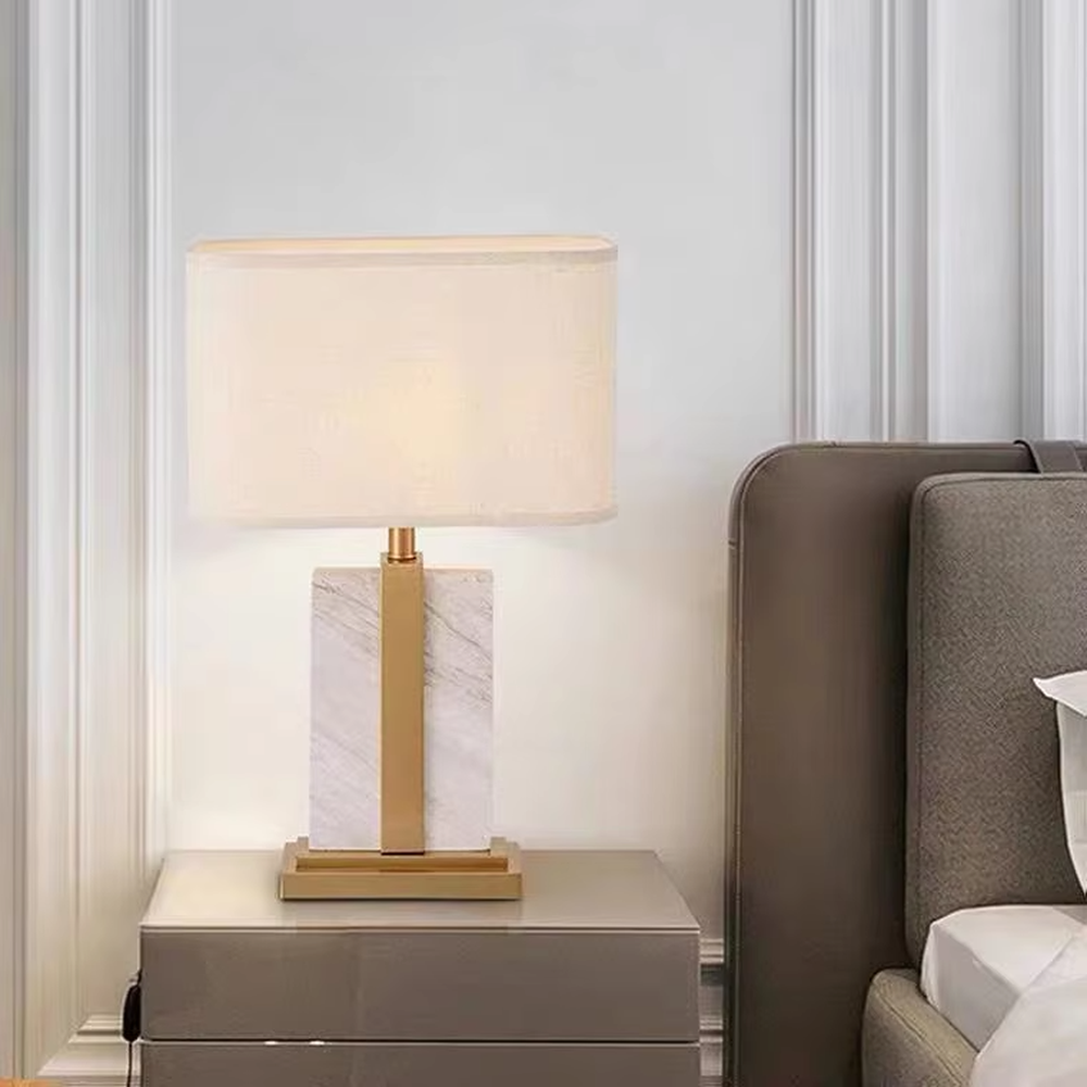 Light luxury color-blocking square base table lamp (black-gold color-blocking base + linen shade), warm light effect, creating a simple and high-end home atmosphere.