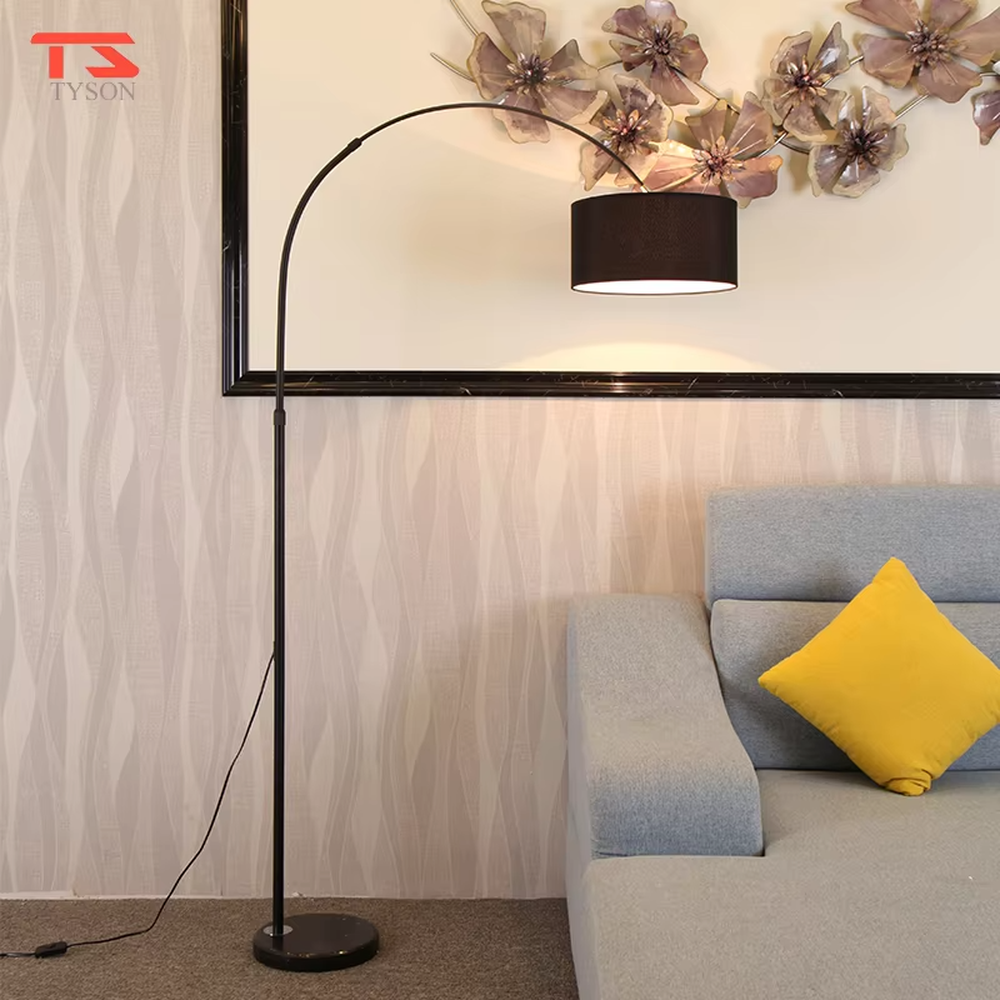 This is a modern minimalist arc floor lamp, featuring a white metal arc pole, a marble base, and a white fabric lampshade, with a simple and elegant design. It is used to provide local lighting and decorate the space, combining practicality and aesthetics. It is suitable for modern home living room corners, bedroom reading areas, high-end hotel leisure areas, luxury apartment living spaces and other places.