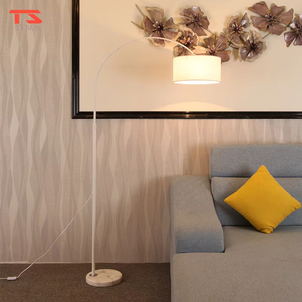 This is a modern minimalist arc floor lamp, featuring a white metal arc pole, a marble base, and a white fabric lampshade, with a simple and elegant design. It is used to provide local lighting and decorate the space, combining practicality and aesthetics. It is suitable for modern home living room corners, bedroom reading areas, high-end hotel leisure areas, luxury apartment living spaces and other places.