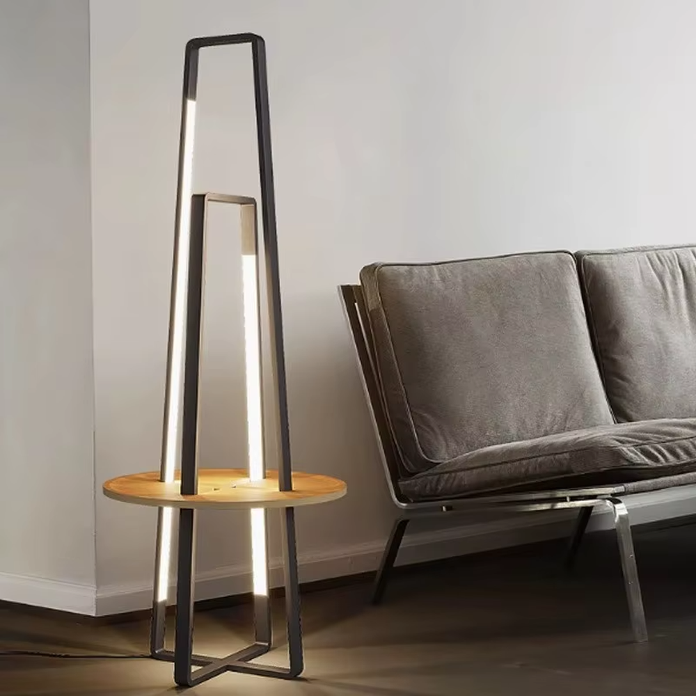 This is a modern geometric double-frame floor lamp with a black metal geometric frame, a wooden storage table, and built-in LED light strips, featuring a minimalist modern and functional design. It is used for space lighting, storage, and decoration, creating a modern luxury atmosphere. It is suitable for modern home living rooms, creative studios, luxury-style residences and other places.