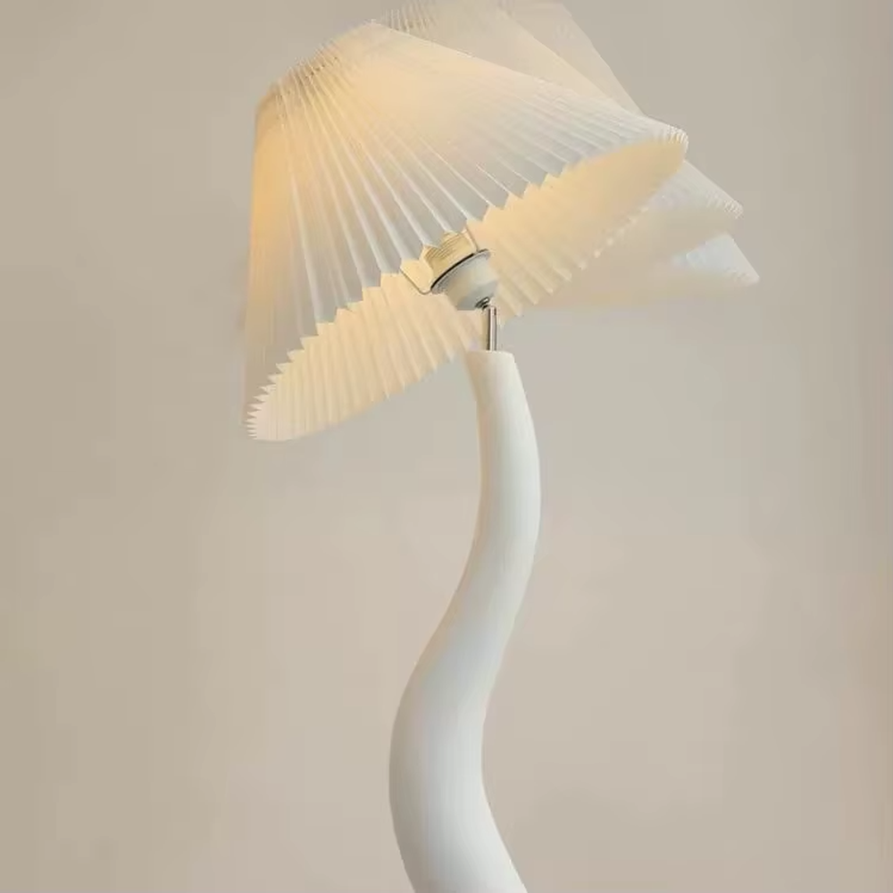 This is a natural artistic wooden curved floor lamp, with a light wood irregular curved bracket and a pleated fabric lampshade, featuring a strong sense of art and natural atmosphere. It is used for space lighting and decoration, creating a natural artistic ambiance. It is suitable for Nordic-style home living rooms, art homestays, creative studios and other places.