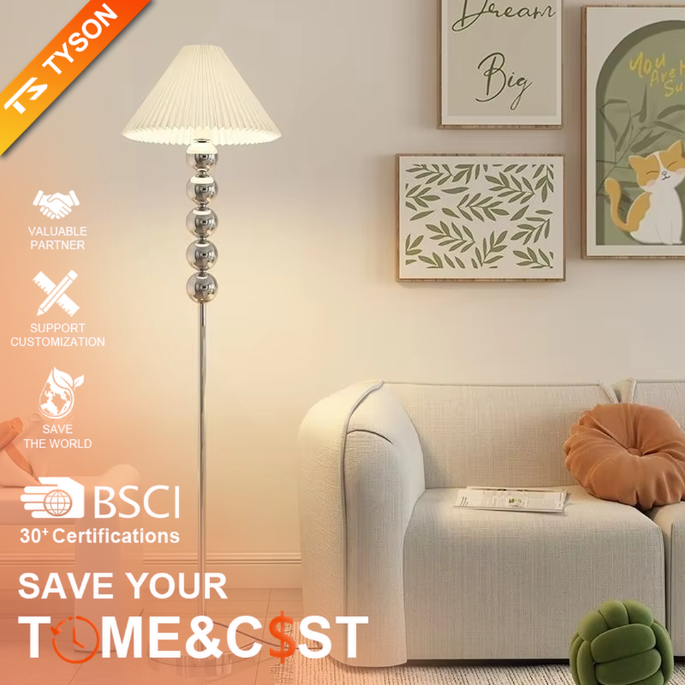 This is a modern warm-style black spherical decorative floor lamp, with a black metal pole featuring spherical decorative elements and a brown fabric lampshade. It has a minimalist and textured design, with soft lighting. It is used for space lighting and decoration, creating a warm and comfortable atmosphere. Suitable for modern minimalist bedrooms, living room corners, Nordic-style homes and other places.