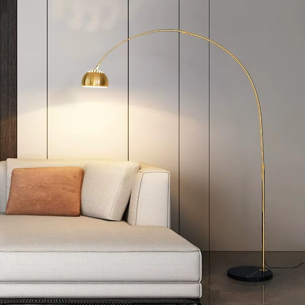 This is a modern luxury arc floor lamp with a golden curved lamp pole, a black marble base, and a golden dome lampshade. It features a simple and elegant design, combining artistry and practicality. It is used for space lighting and decoration, creating a luxurious and fashionable ambiance. It is suitable for modern home living rooms, luxury apartment living areas, high-end hotel leisure spaces and other places.