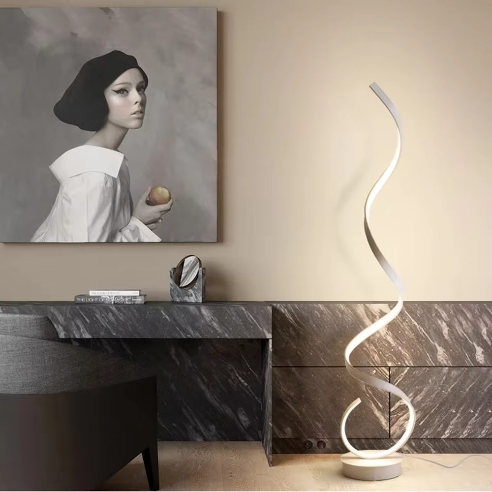 This is a modern artistic spiral floor lamp, with a white spiral shape and a minimalist base, featuring a strong artistic sense and modern style. It is used for space lighting and decoration, creating an artistic atmosphere. It is suitable for modern art home living rooms, designer studios, art exhibition halls and other places.