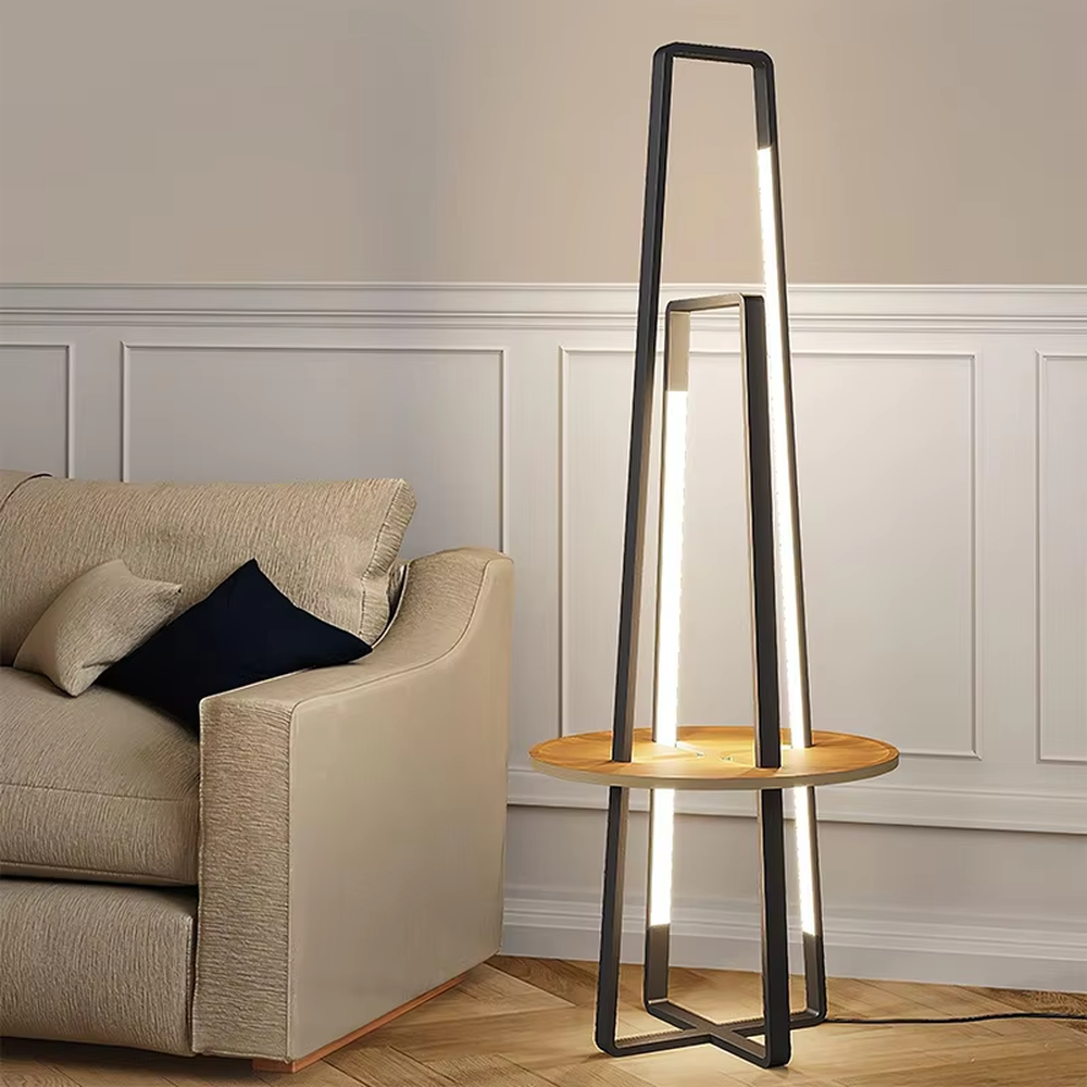 This is a modern geometric double-frame floor lamp with a black metal geometric frame, a wooden storage table, and built-in LED light strips, featuring a minimalist modern and functional design. It is used for space lighting, storage, and decoration, creating a modern luxury atmosphere. It is suitable for modern home living rooms, creative studios, luxury-style residences and other places.