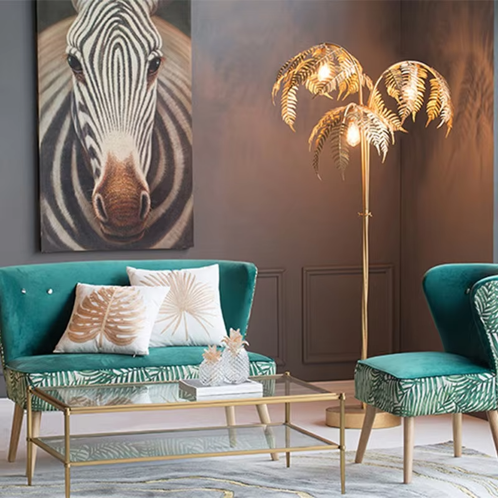 This is a tropical artistic floor lamp with golden palm leaf-shaped lamp heads and a metal pole, featuring a strong tropical artistic sense. It is used for space lighting and decoration, creating a tropical artistic atmosphere. It is suitable for tropical-style home living rooms, creative cafes, art homestays and other places.