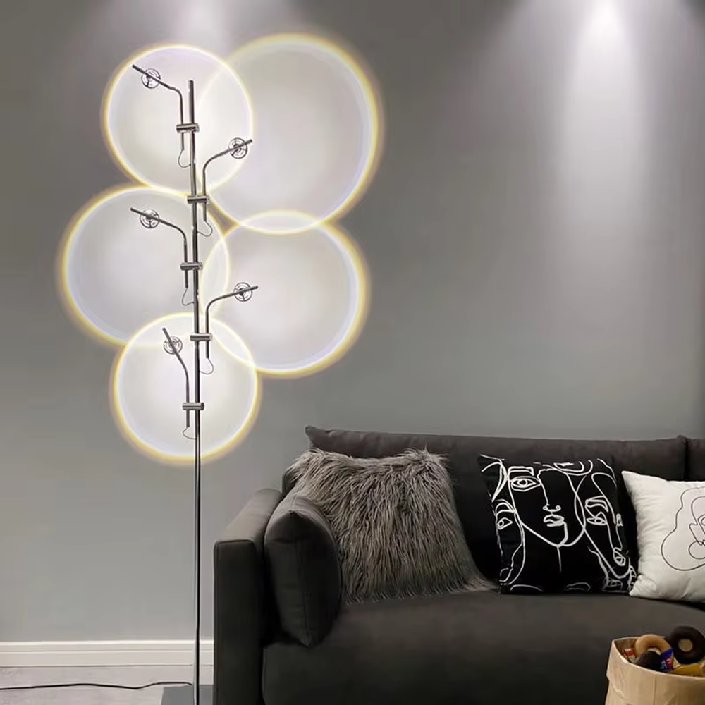 This is a modern artistic multi-circular light and shadow floor lamp, with a metal branch-like structure and multiple circular light-emitting panels. The light projects circular light and shadow with yellow edges, featuring a strong sense of modern art and light-shadow hierarchy. It is used for space lighting and decoration, creating a warm and artistic atmosphere. Suitable for modern bedrooms, artistic living rooms, designer studios and other places.