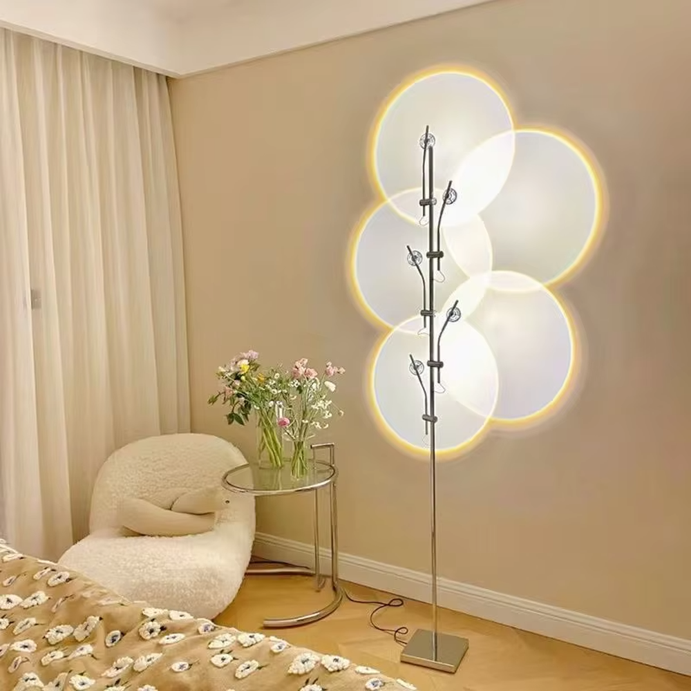 This is a modern artistic multi-circular light and shadow floor lamp, with a metal branch-like structure and multiple circular light-emitting panels. The light projects circular light and shadow with yellow edges, featuring a strong sense of modern art and light-shadow hierarchy. It is used for space lighting and decoration, creating a warm and artistic atmosphere. Suitable for modern bedrooms, artistic living rooms, designer studios and other places.