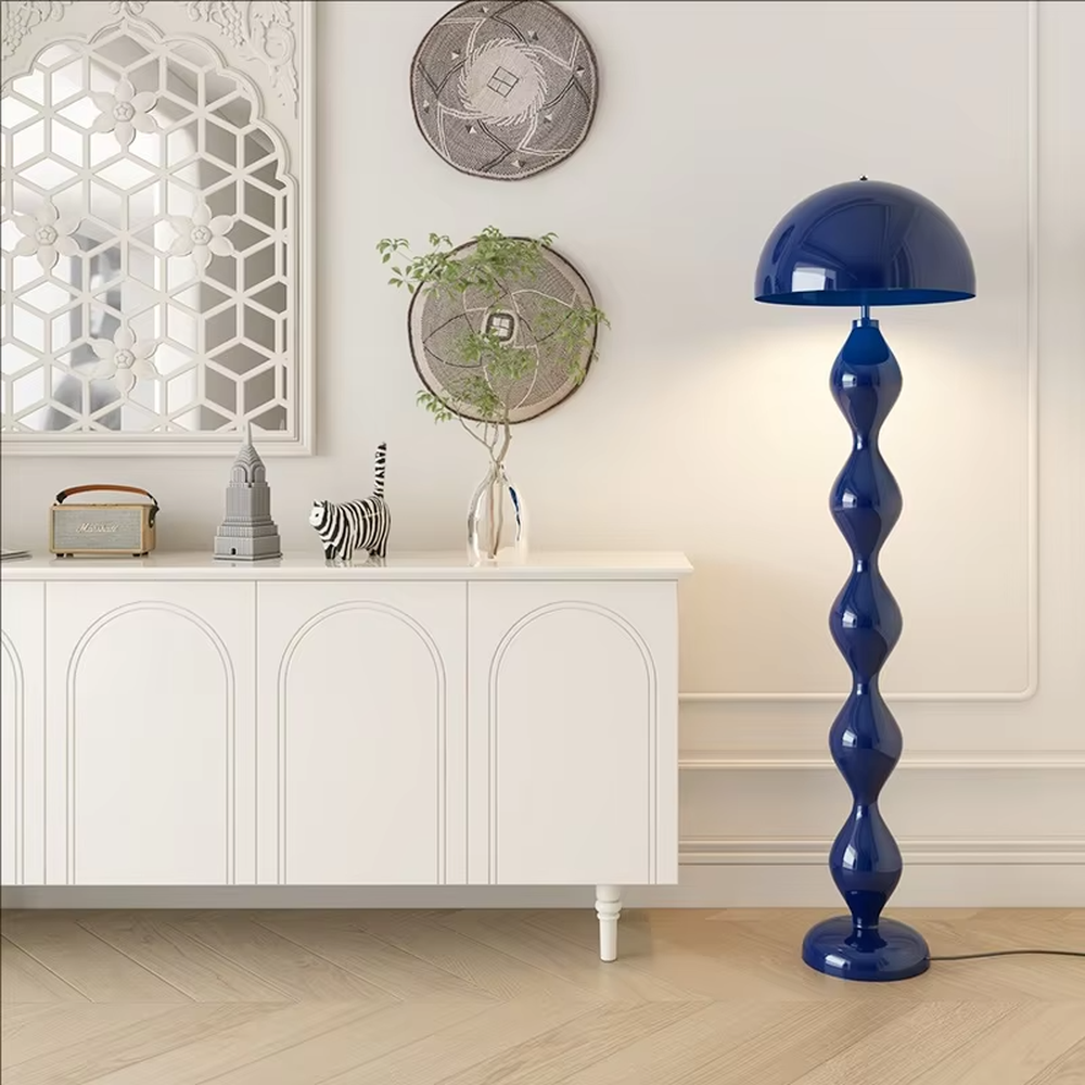 This is a modern artistic floor lamp with an olive green wavy lamp pole and a dome lampshade, featuring a unique and dynamic design. It is used for space lighting and decoration, creating a warm and artistic ambiance. It is suitable for modern home bedrooms, living rooms, characteristic homestays, art apartments and other places.