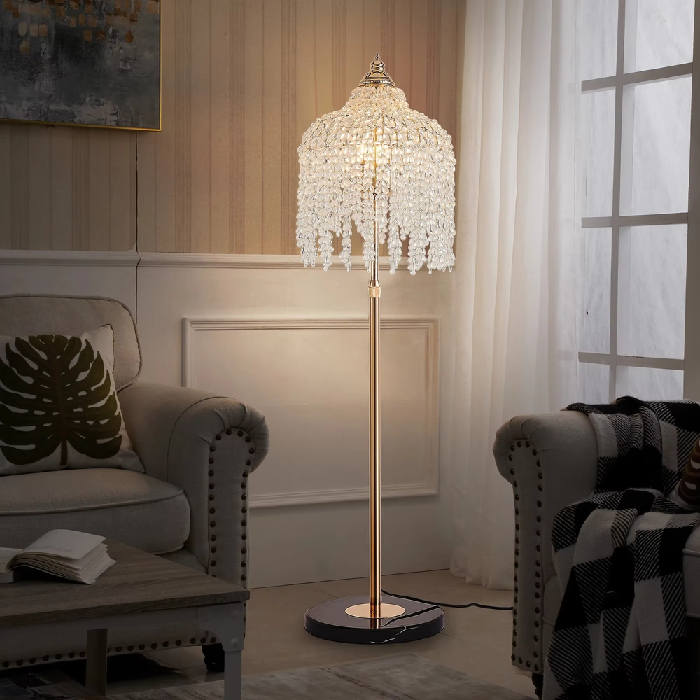 This is a luxury crystal floor lamp with a golden lamp pole, a marble base, and a cascading crystal lampshade. It features a luxurious and elegant design that shines brilliantly under light. It is used for space lighting and decoration, creating a noble and luxurious ambiance. It is suitable for luxury-style home living rooms, high-end hotel leisure areas, luxury villa living rooms and other places.