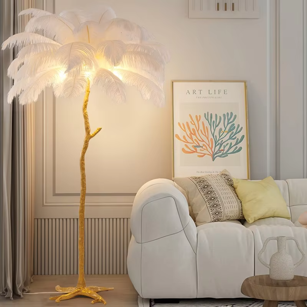 This is a light luxury artistic feather-shaped floor lamp, with a golden branch-shaped metal bracket and numerous pink ostrich feathers. It features a romantic and luxurious design, with warm and soft lighting. It is used for space ambient lighting and decoration, creating a romantic artistic atmosphere. Suitable for light luxury-style bedrooms, internet-famous check-in shops, art homestays and other places.